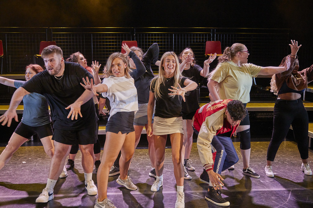 Students on stage for a musical theatre performance