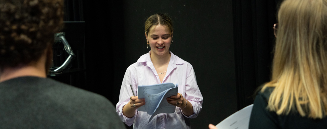 Student reading a script as part of a Drama workshop