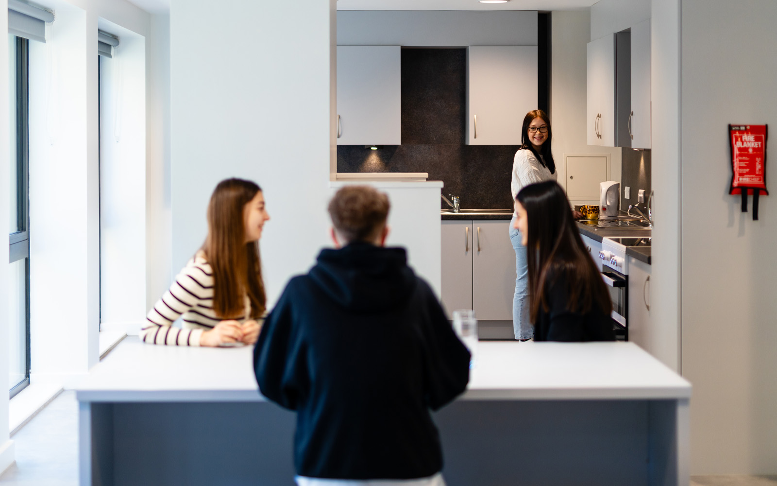 A group of students chatting in a ktichen