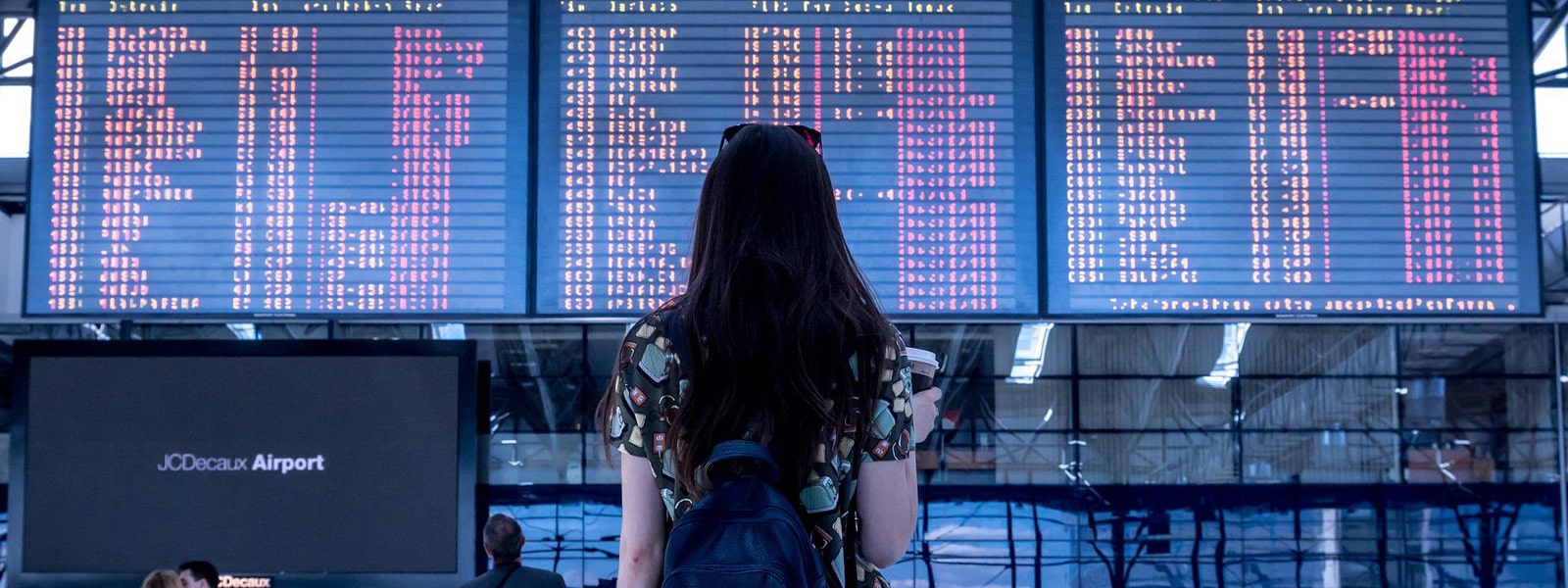 A student looking at airport departures