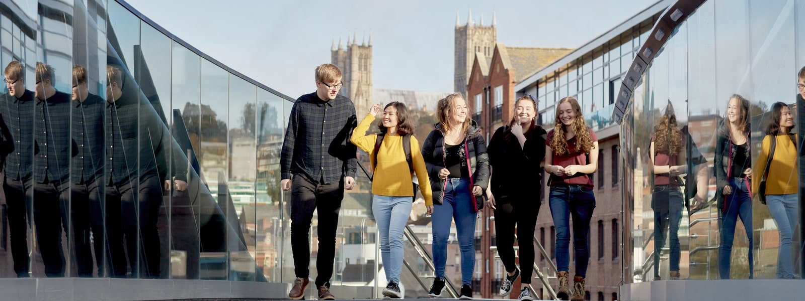 Students walking over a university bridge