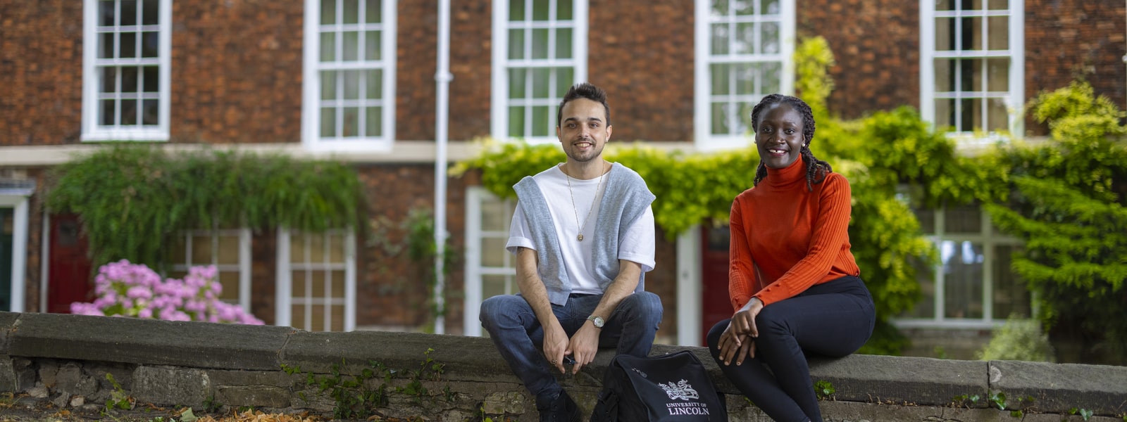 International Students Sat on a Wall