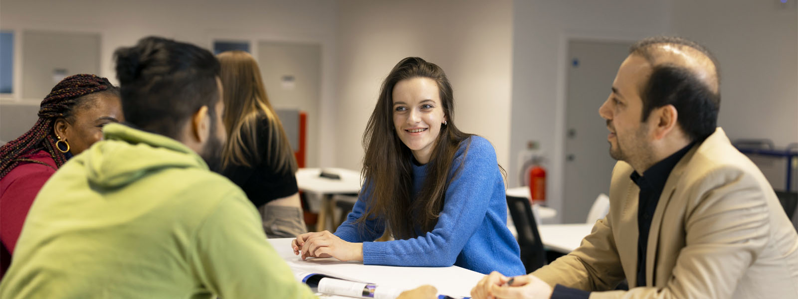 Staff and students talking in a seminar room